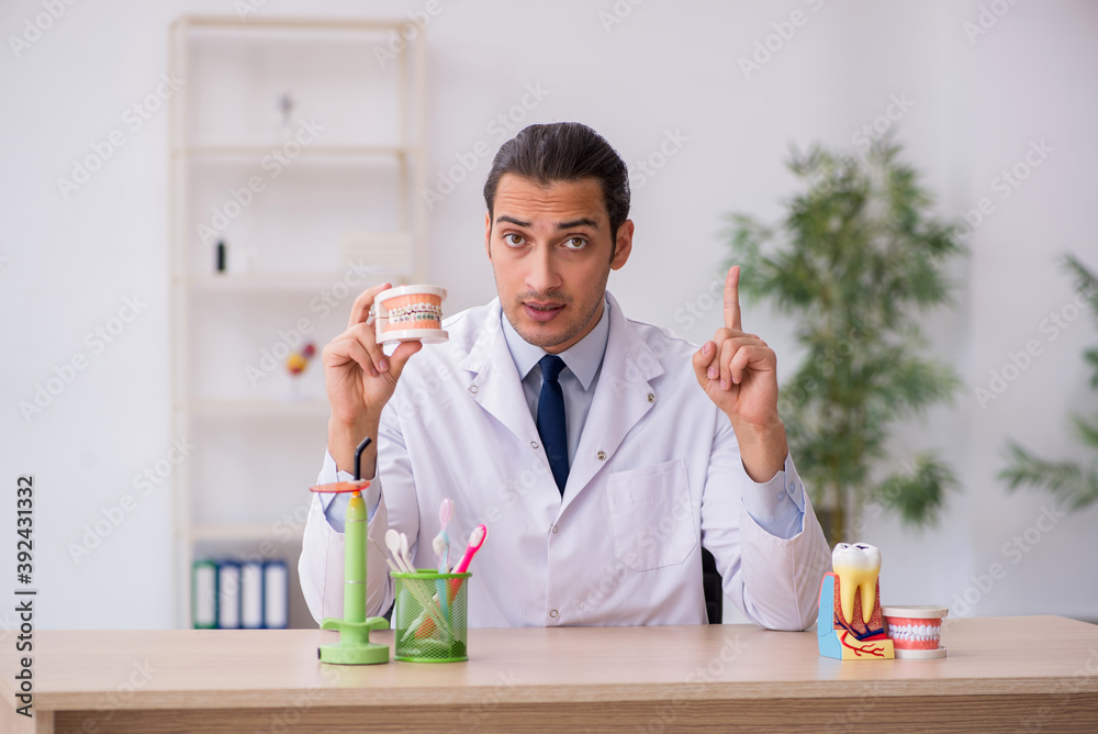 Young male doctor stomatologist working in the clinic Young male doctor stomatologist working in the clinic