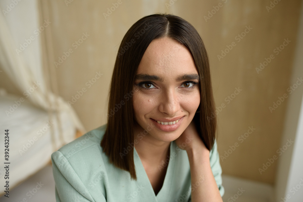 Close-up portrait of a young dark-haired woman. The girl is dressed in a jacket. Close-up portrait of a young dark-haired woman. The girl is dressed in a jacket.