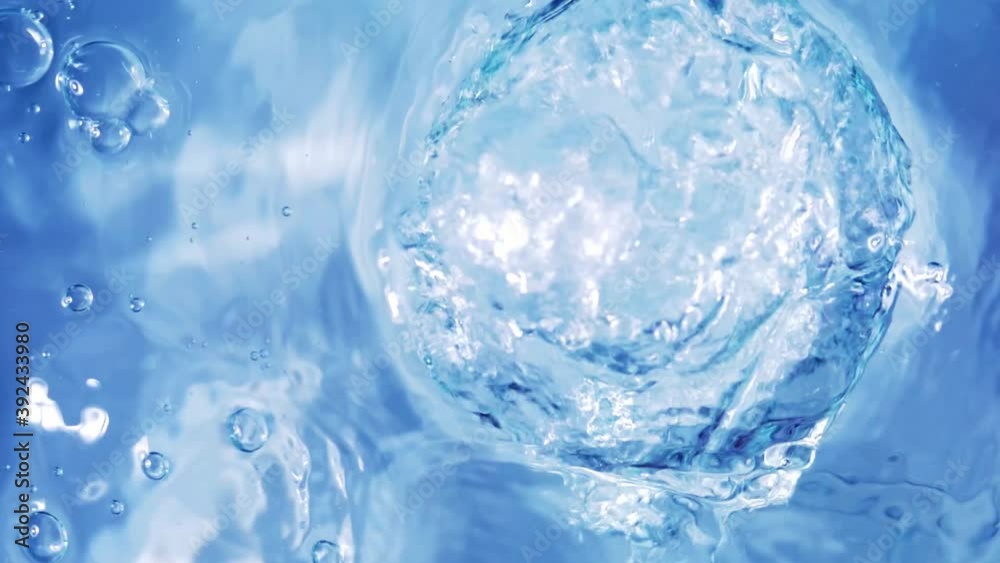 Top view slow motion of drop falling into the water surface and diverging circles on white background Top view slow motion of drop falling into the water surface and diverging circles on white background