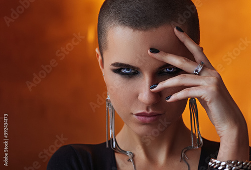 Slika na platnu A bald girl with a wet face and mascara on her face holds her hand to her face