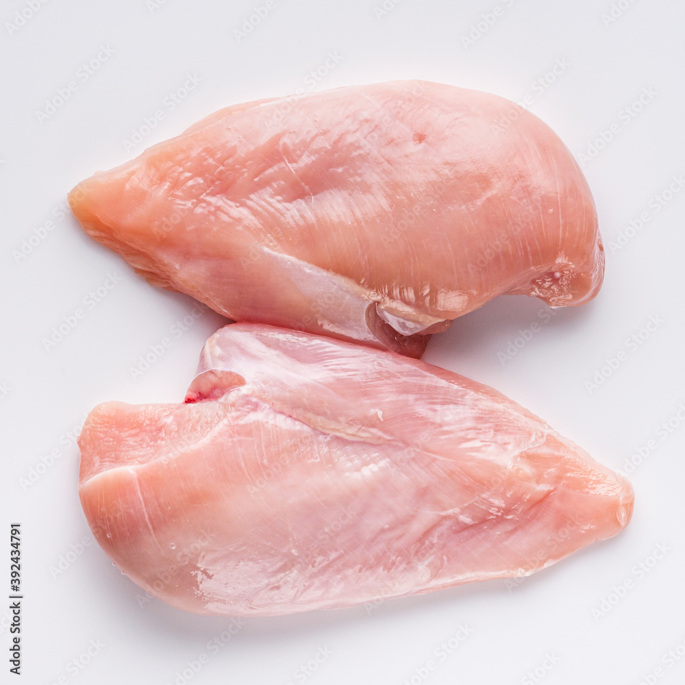 raw chicken fillet on a white acrylic background raw chicken fillet on a white acrylic background