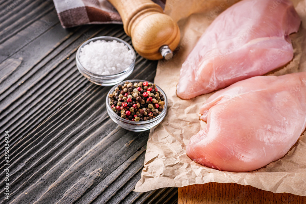 raw chicken fillet on a dark wooden rustic background