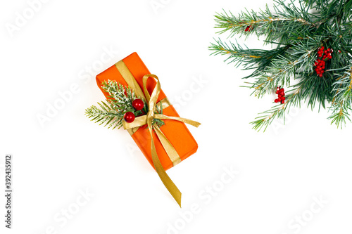 Red gift box and green fir tree spruce branch isolated on white background. photo