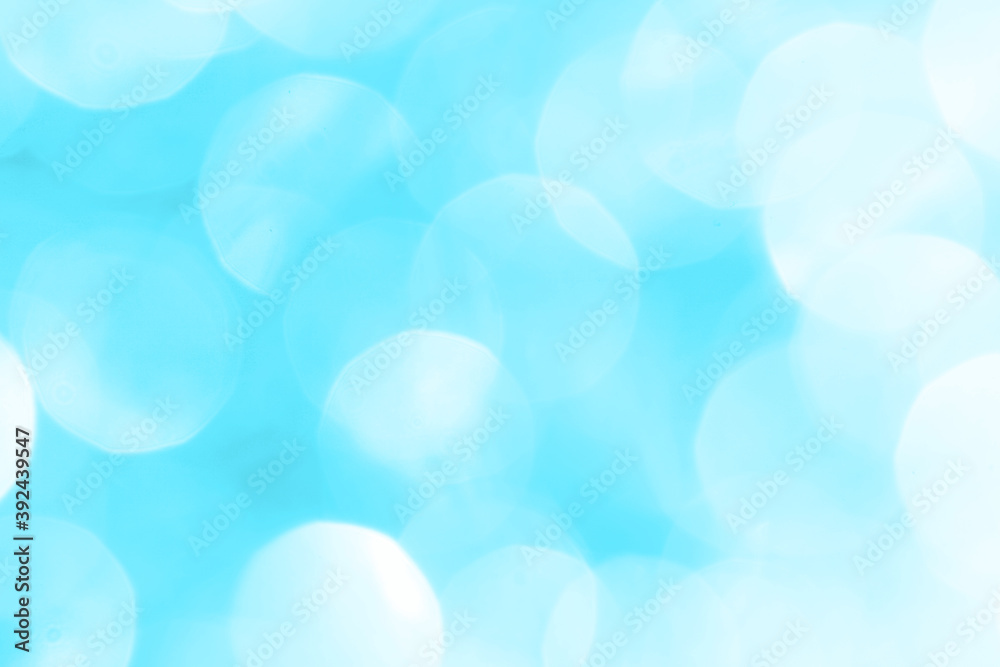 Bokeh light on blue background, sky with circle glitter light blue. Snow abstract soft glowing with vivid bright light and bokeh blur effect. 