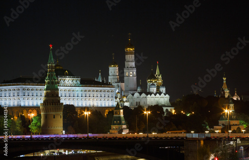 The Moscow Kremlin in evening. Shot in long focal length. Bolshoy Kamenny brige, towers, wall, temples, Ivan The Great bell tower