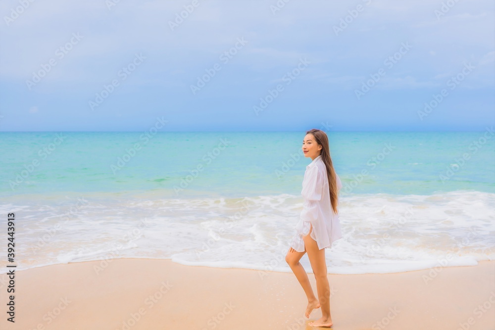 Portrait beautiful young asian woman relax leisure smile around beach sea ocean