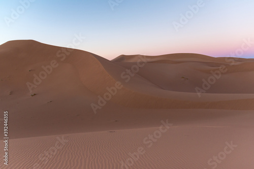 Huge desert dunes of Erg Chigaga  at the gates of the Sahara  al amanecer. Morocco. Concept of travel and adventure.
