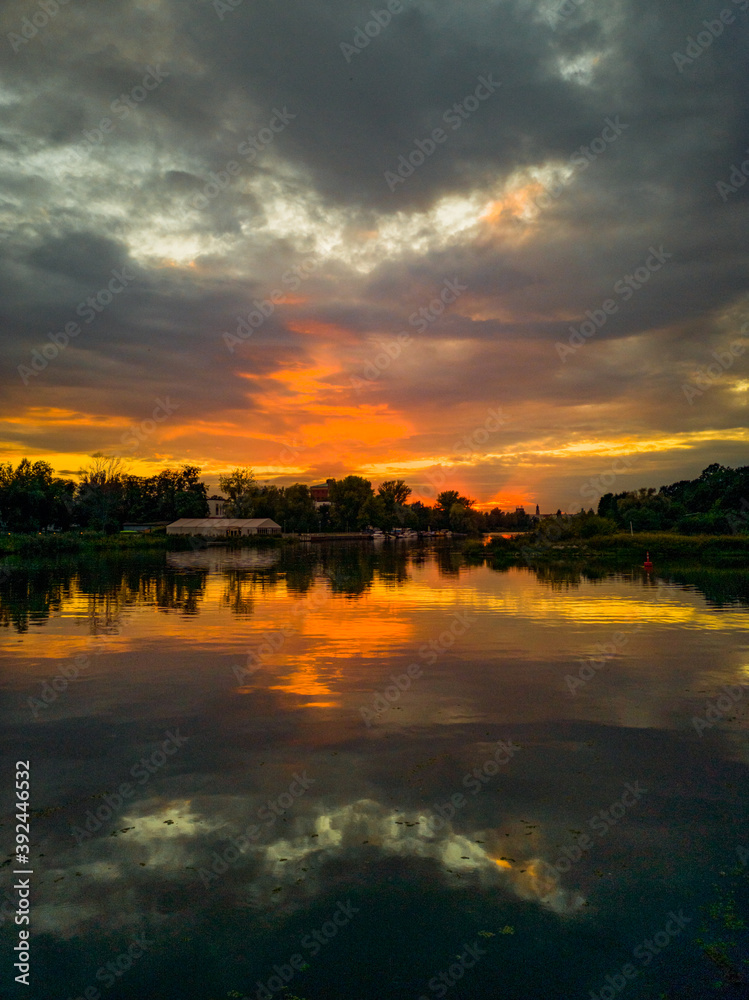 Cloudy sunset reflecting in Odra river