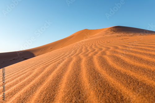 Daytime close-up desert dunes of Erg Chigaga, at the gates of the Sahara. Morocco. Concept of travel and adventure.