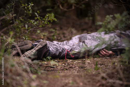 Man's body found dead In the woods. Dead body in the forest. Murder in the woods