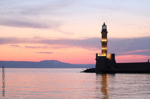 Chania port lighthouse at sunset.