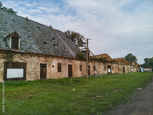 Old ruined barracks in small old village © wierzchu92