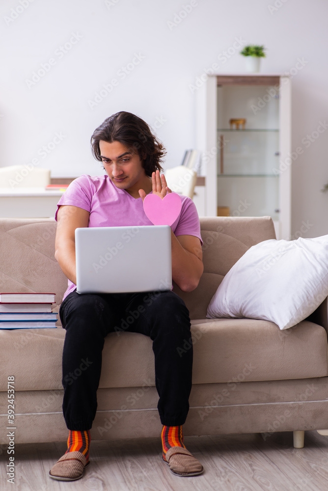 Male student in love preparing for exams at home Male student in love preparing for exams at home