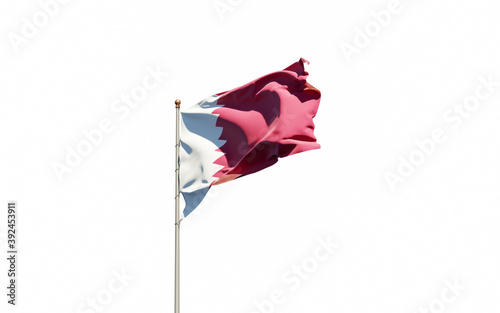 National state flag of Qatar fluttering at sky background.