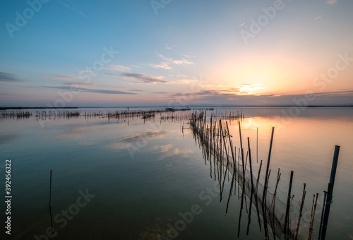 traditional fishing nets in the water Albufera Valencia reflections sky at natural lake Natural Park Spain