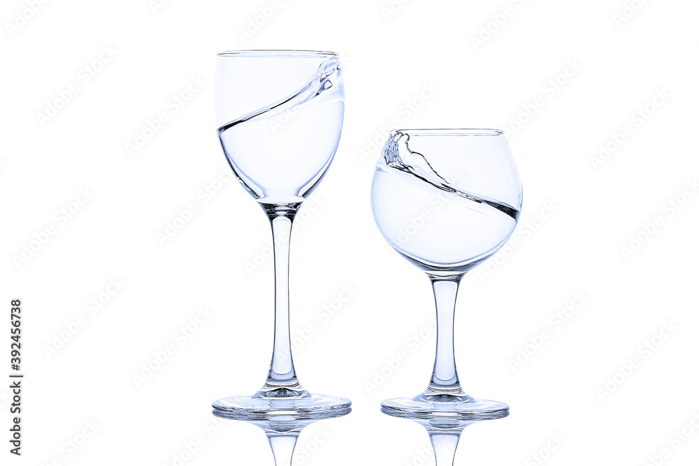 Splash of liquid in glasses isolated on white background Splash of liquid in glasses isolated on white background