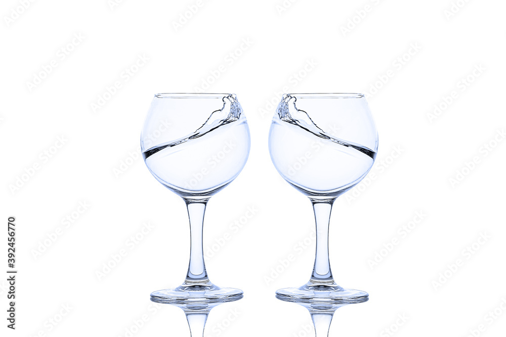 Splash of liquid in glasses isolated on white background Splash of liquid in glasses isolated on white background