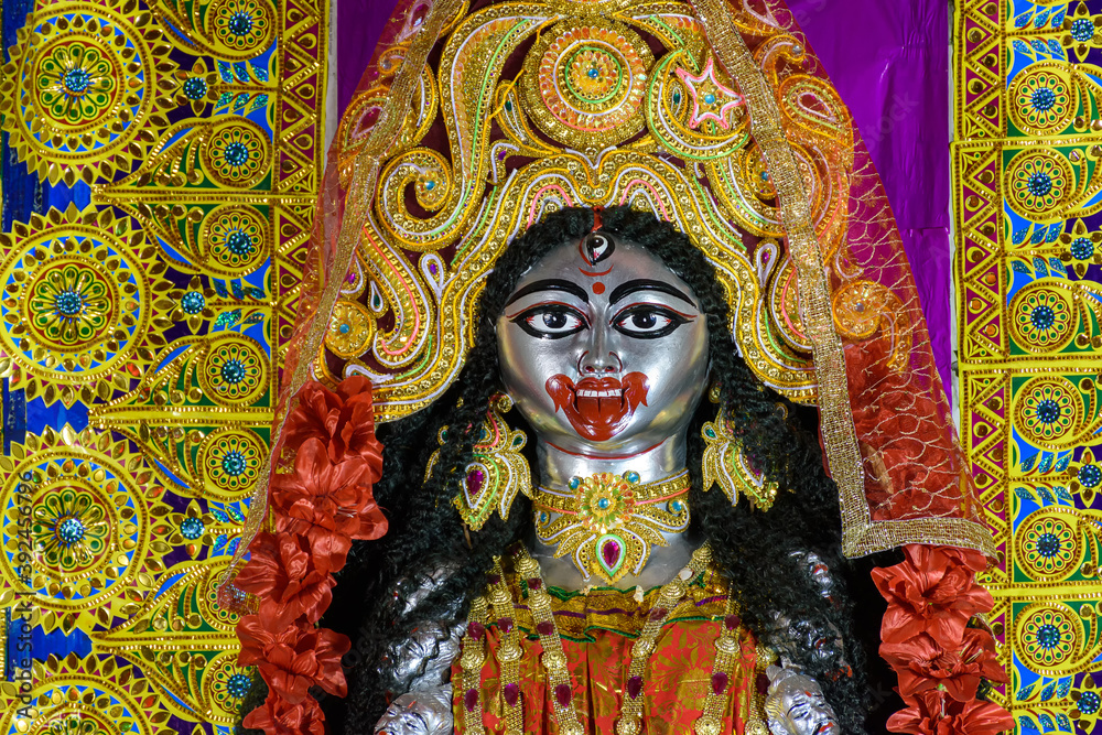 Obraz premium Idol of Goddess Maa Kali at a decorated puja pandal in Kolkata, West Bengal, India. Kali puja also known as Shyama Puja is a famous religious festival of Hinduism.