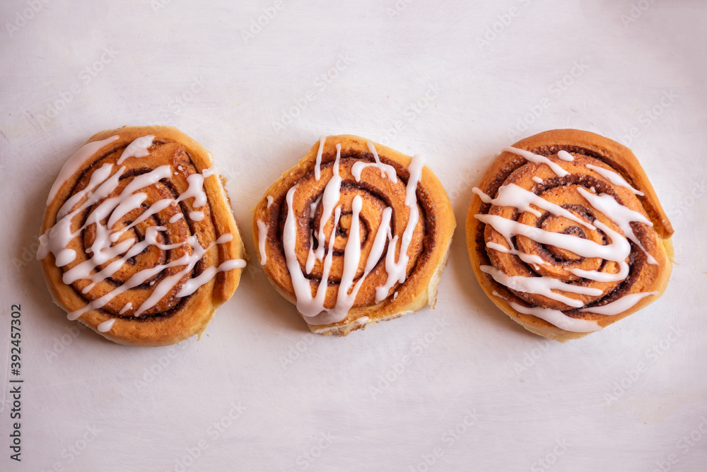 Fresh home baked sweet cinnamon buns with frosting Fresh home baked sweet cinnamon buns with frosting