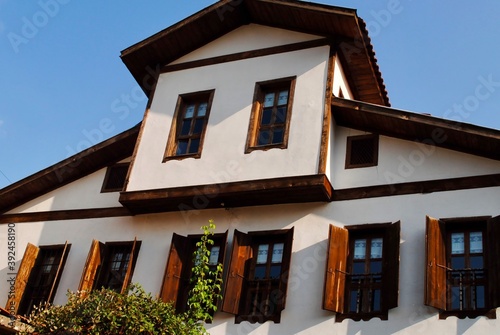 Low angle of traditional ottoman house windows against blue sky in Safranbolu, Turkey. UNESCO world heritage site. 