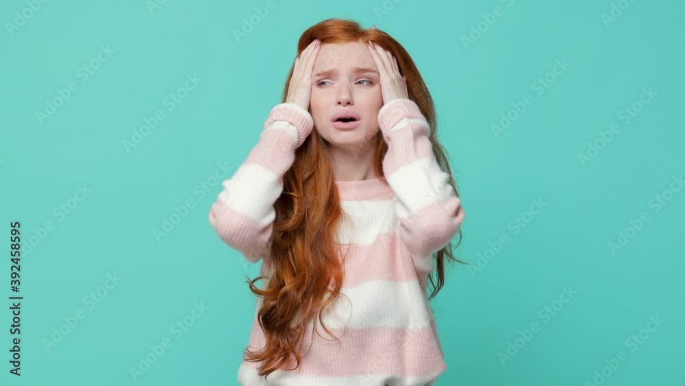 Displeased shocked irritated ginger redhead young girl in white pink sweater isolated on blue turquoise background in studio. People lifestyle concept. Looking camera ask what spreading hands swearing Displeased shocked irritated ginger redhead young girl in white pink sweater isolated on blue turquoise background in studio. People lifestyle concept. Looking camera ask what spreading hands swearing