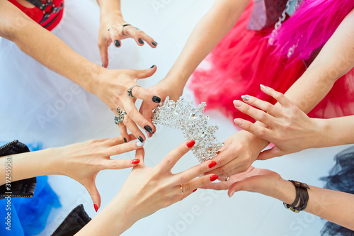 The girls ' hands reach for the crown. Who will be the Queen, the boss or the first beauty. The concept of competition and competition.