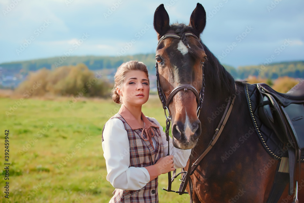 Obraz premium Beautiful elegant female rider next to the horse's muzzle. People and animals. Rider.