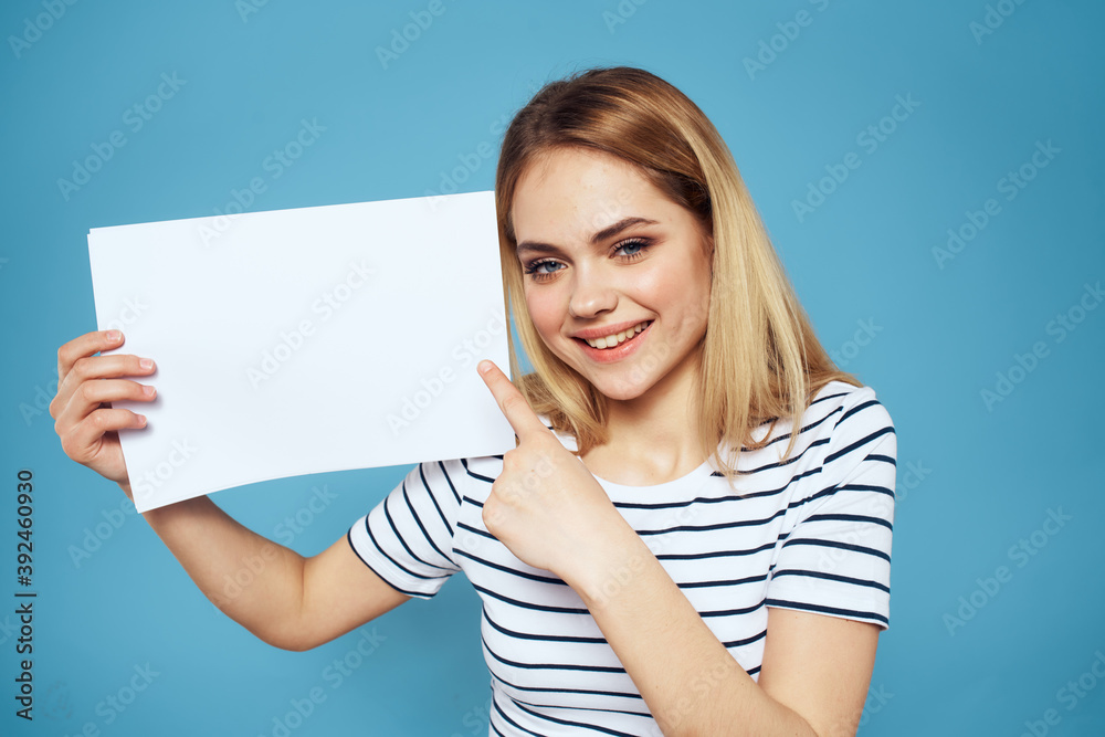 Woman holding sheet of paper striped T-shirt Copy Space cropped view blue background Woman holding sheet of paper striped T-shirt Copy Space cropped view blue background