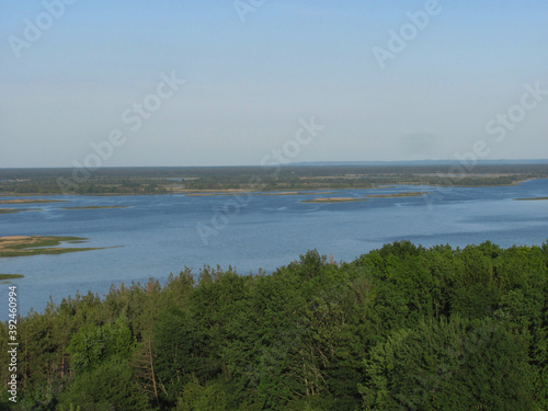 landscape background  green forest  river with islands and blue sky