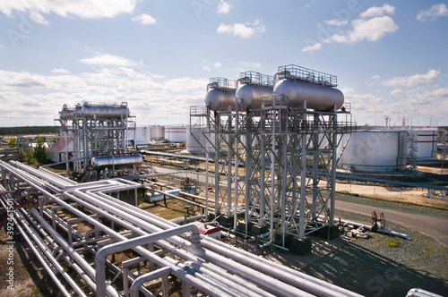 Large Oil Industrial Facility, equipment, pipelines, tanks with oil products, utilities.