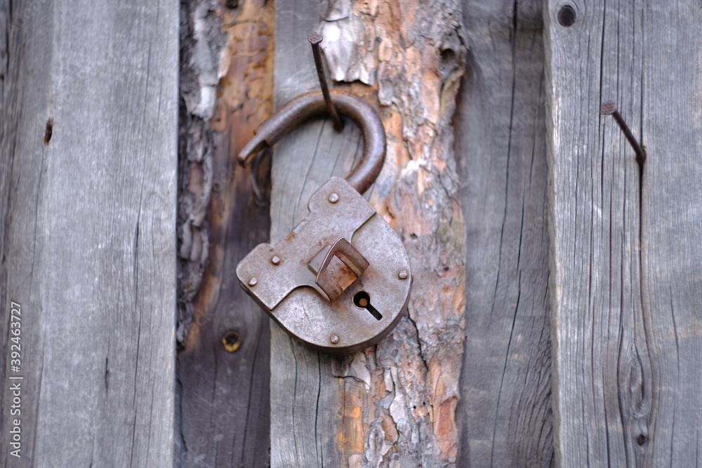 old rusty lock on wooden door