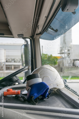 Personal protective equipment in the cabin of a truck that transports dangerous goods, consisting of a helmet, protective glasses, gas mask and an explosimeter.