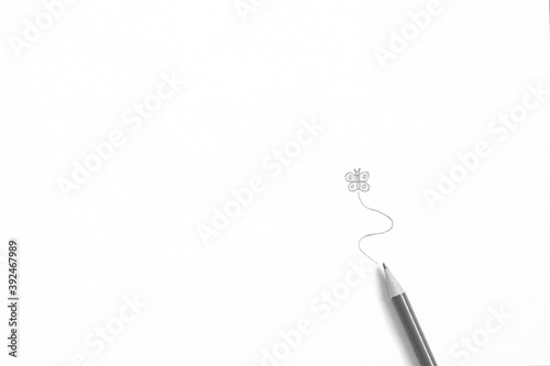 A minimalistic abstract black and white close up portrait of a drawn butterfly on a white background with a drawing pencil beneath it.