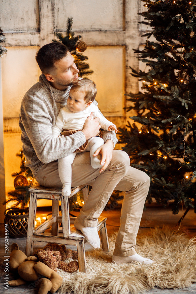 Handsome father hold little daughter in arms, caring dad spend winter holidays with cute toddler, smiling, enjoy Christmas time at home, fatherhood and childhood concept