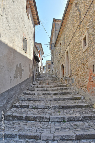 Fototapeta Naklejka Na Ścianę i Meble -  A narrow street among the old houses of Pietrelcina, a medieval village in the Campania region, Italy.