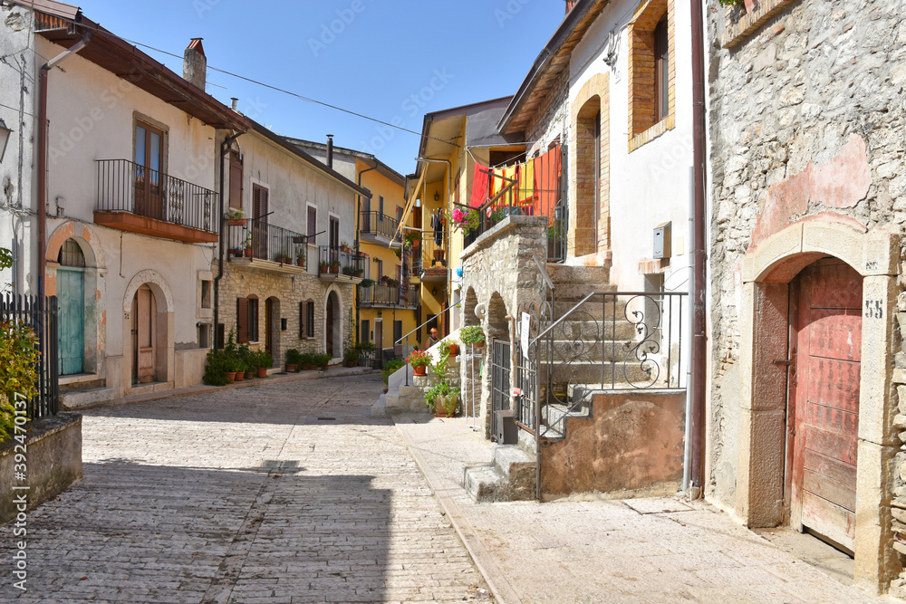 A narrow street among the old houses of Pietrelcina, a medieval village in the Campania region, Italy.