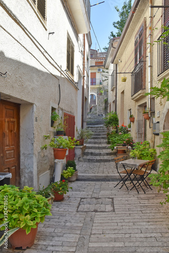 Fototapeta Naklejka Na Ścianę i Meble -  A narrow street among the old houses of Pietrelcina, a medieval village in the Campania region, Italy.