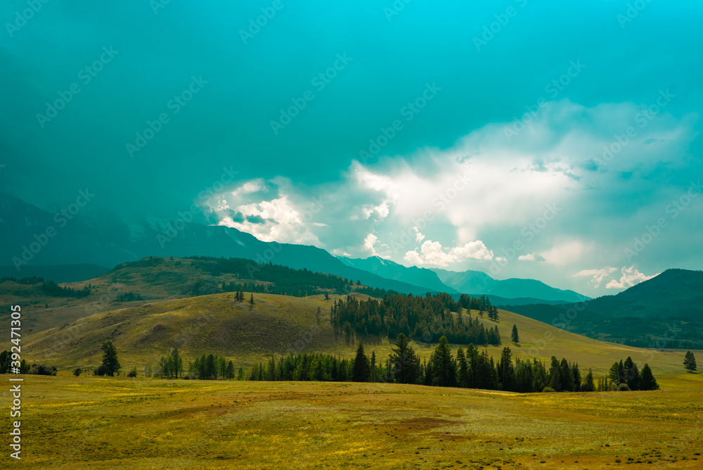 Majestic mountain landscape under the sky with clouds. Cloudy sky before the storm