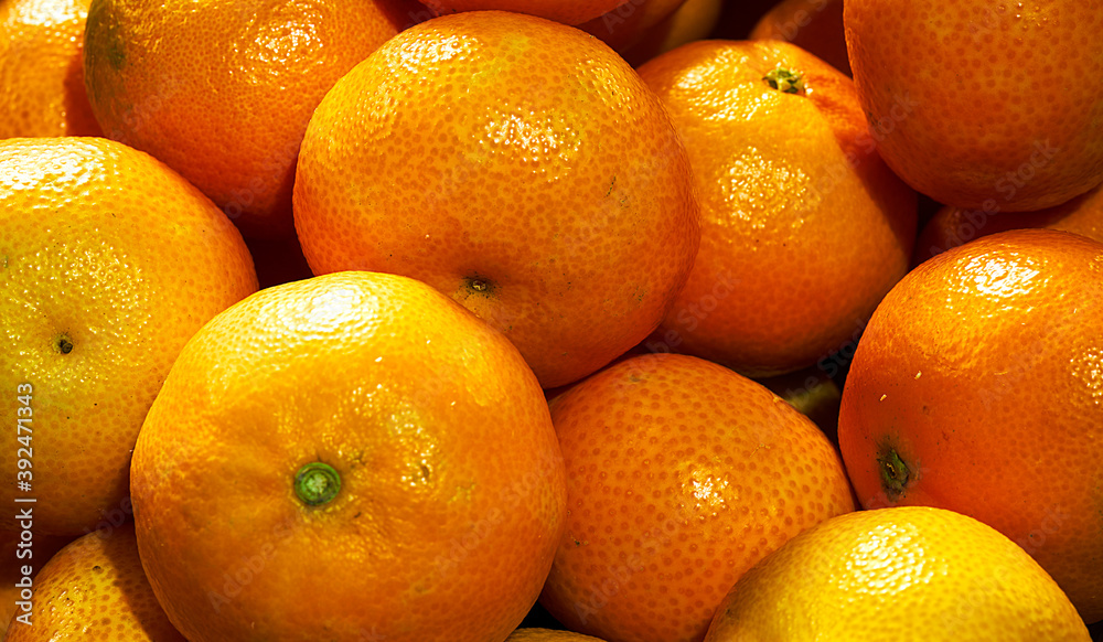 A bunch of fresh mandarins, as background A bunch of fresh mandarins, as background