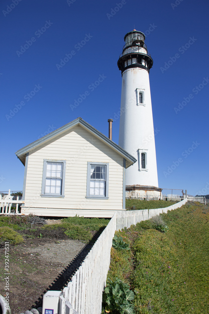 Pigeon Point Lighthouse and keeper's quarters on the California coast on a bright, clear, sunny day