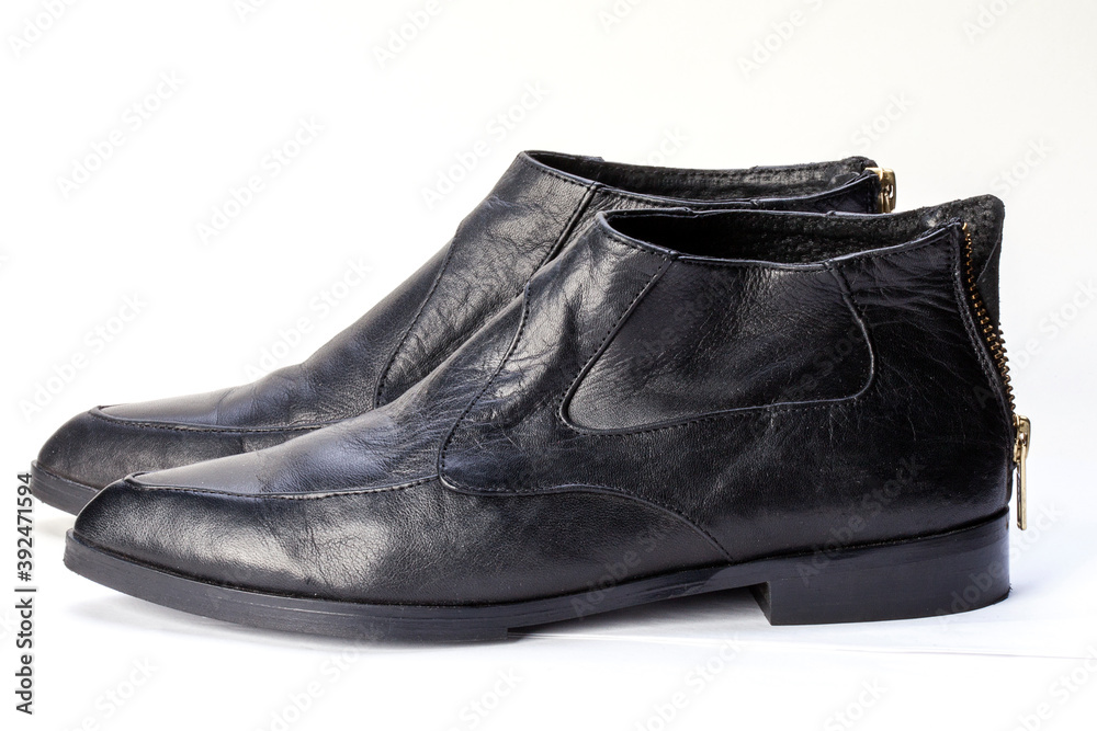 Close-up of women's black leather chelsea boots on a white background. Women's shoes for the city, urban lifestyle or travel. Fashion, design and shoes concept Close-up of women's black leather chelsea boots on a white background. Women's shoes for the city, urban lifestyle or travel. Fashion, design and shoes concept