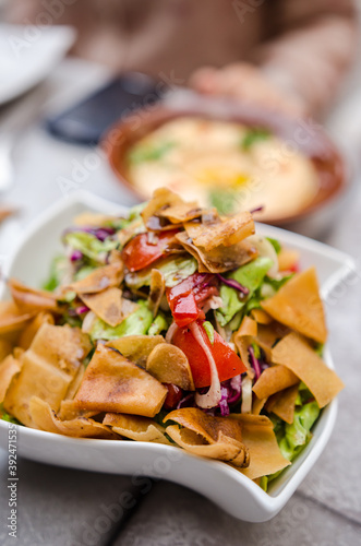 Fattoush, a levantine fresh salad with roasted flat bread and season vegetables photo