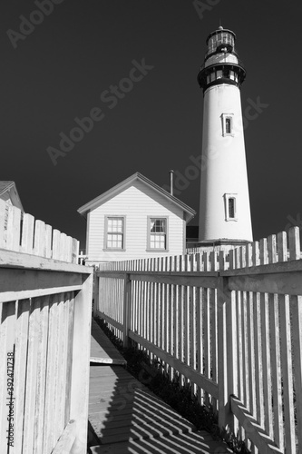 Pigeon Point Lighthouse and keeper's quarters on the California coast on a bright, clear, sunny day photo