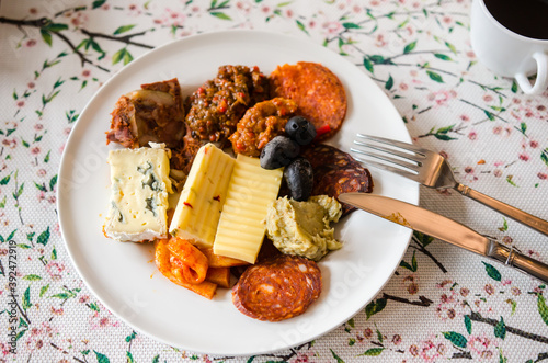 Romanian and hungarian appetizers plate with cheese, salami, sausages, zacusca, aubergines dip photo