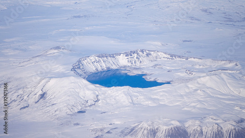 Cold arctic landscapes seen from the airplane with crystal clear blue waterd in a lake.  photo