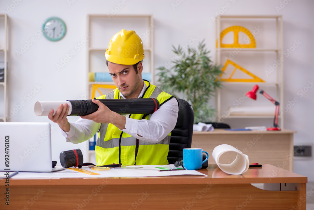 Young male architect working in the office Young male architect working in the office