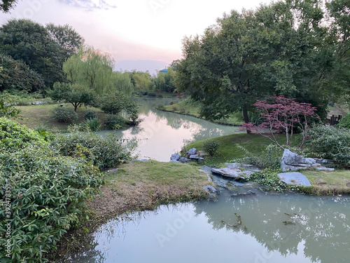 Walking through the Slender West Lake park in Yangzhou, China you can discover many sights like the one you see here - beautiful combination of plants and water features photo