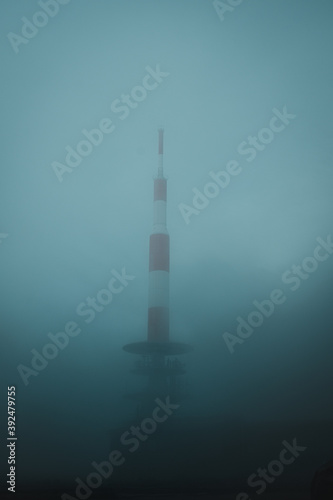 large radio antenna station, space ship looking building in the fog. Building on top of a mountain. Harz National Park in Germany