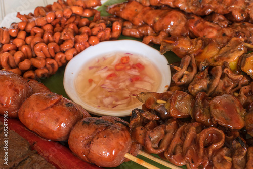 Closeup of a variety of diffrent kinds of barbecued meat and innards served with spiced vinegar. Philippine street food. photo