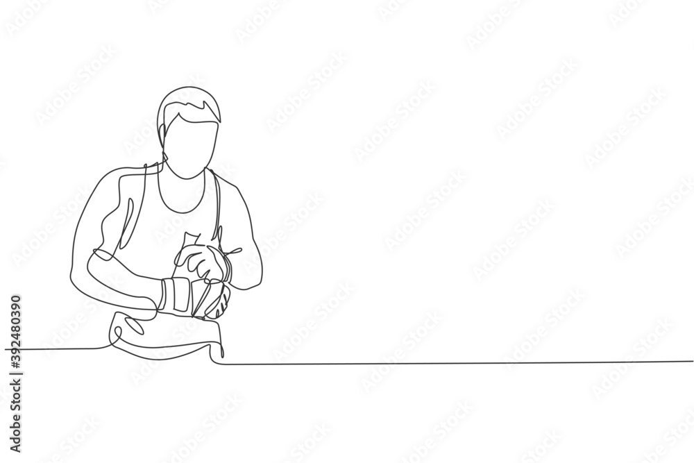 One continuous line drawing of young sporty man kickboxer athlete wrap a strap bandage to prepare a fighting at gym center. Combative sport concept. Dynamic single line draw design vector illustration